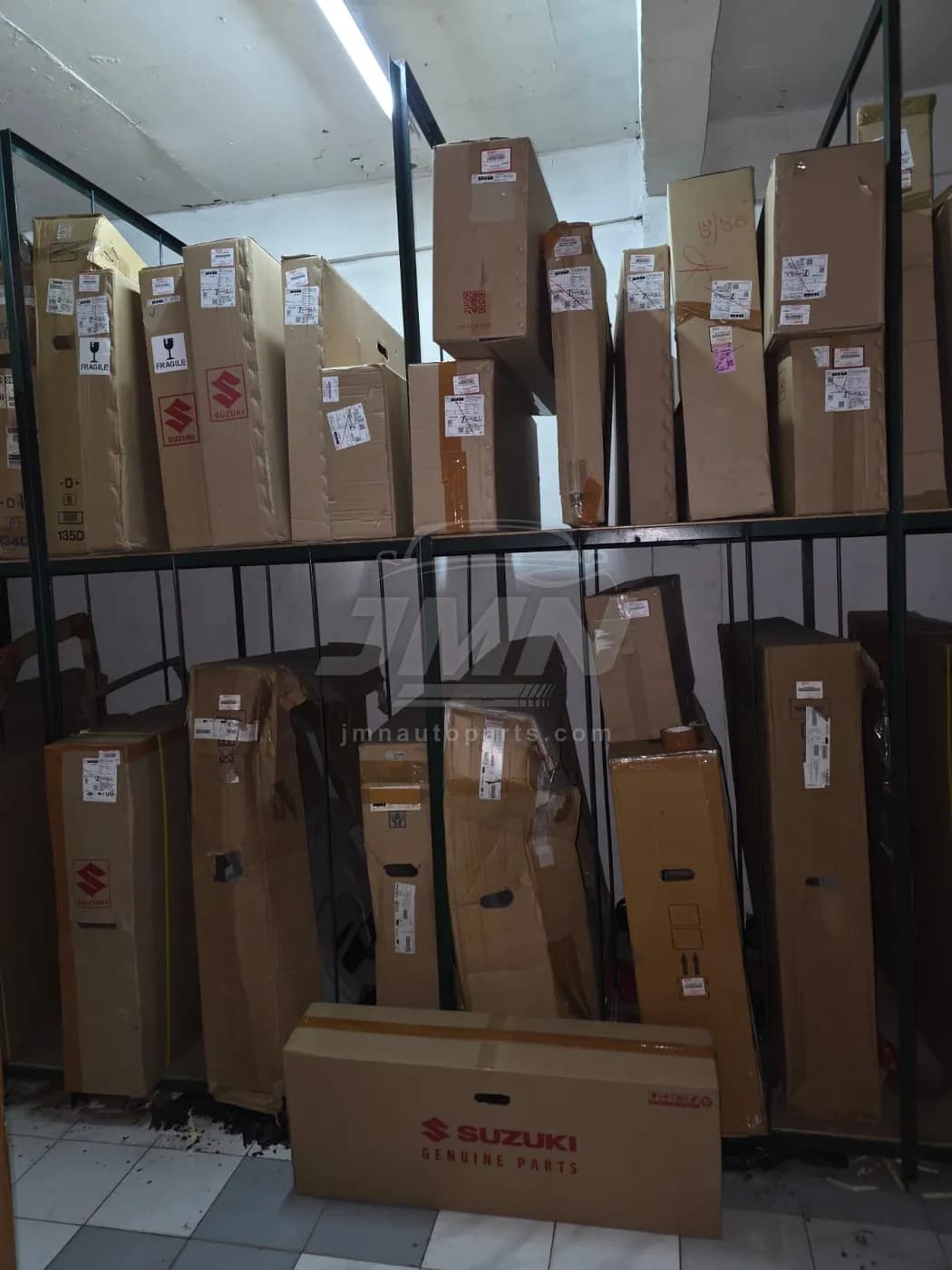 Racking bay holding large Suzuki body panels such as doors and fenders in original cartons